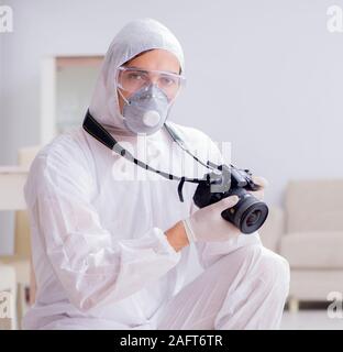 The forensic expert at crime scene doing investigation Stock Photo