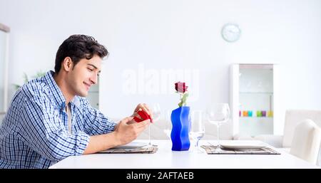 The man alone preparing for romantic date with his sweetheart Stock Photo