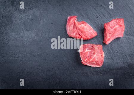 Chopped Beef Steak (selective focus) on a slate slab (close-up shot) Stock Photo