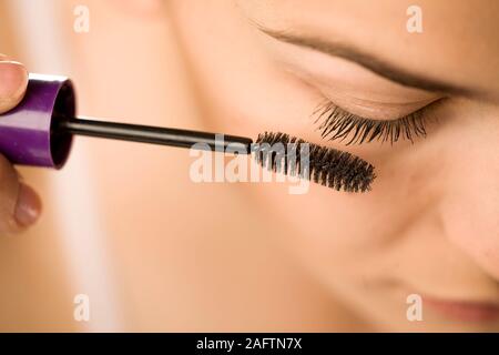 closeup of woman applyinhg mascara on her eyelashes Stock Photo