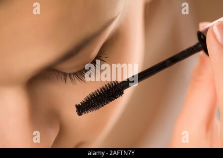 closeup of woman applyinhg mascara on her eyelashes Stock Photo
