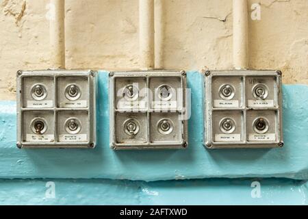 close up of 12 vintage electrical toggle switches on a wall in Sir Richard Arkwright's cotton and textile mill at Masson Mills Museum Derbyshire UK Stock Photo