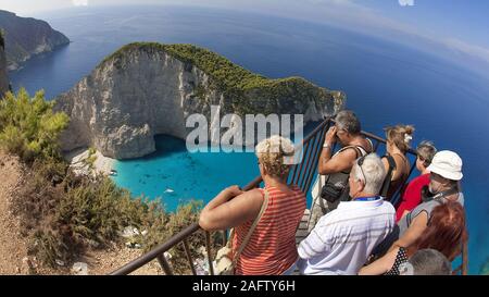 People enjoying the view on Shipwreck Bay, one of the most beautiful beaches in Greece, Zakynthos island, Greece Stock Photo