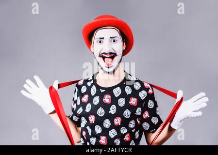 Mime poses and grimaces in the studio Stock Photo