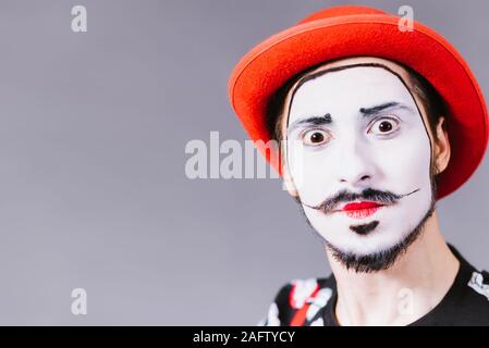 Mime poses and grimaces in the studio Stock Photo