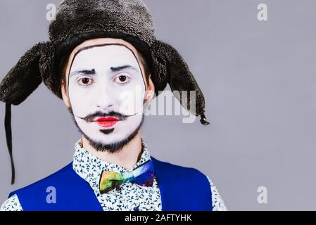 Mime poses and grimaces in the studio Stock Photo