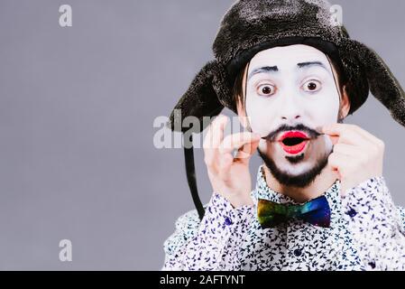 Mime poses and grimaces in the studio Stock Photo