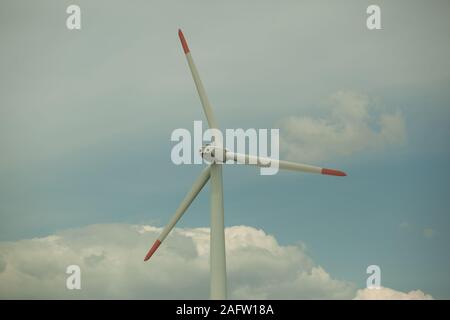 Close up abstract view of a giant wind turbine with blue sky background Stock Photo