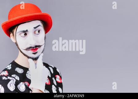 Mime poses and grimaces in the studio Stock Photo