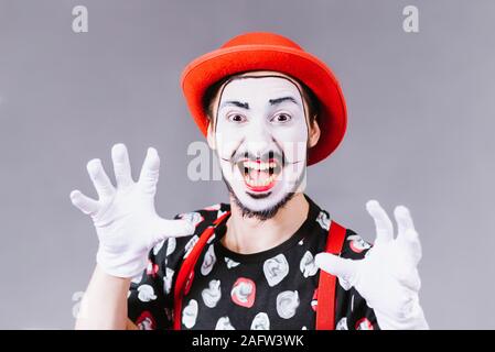Mime poses and grimaces in the studio Stock Photo