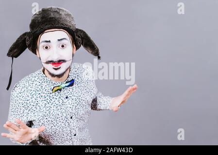 Mime poses and grimaces in the studio Stock Photo