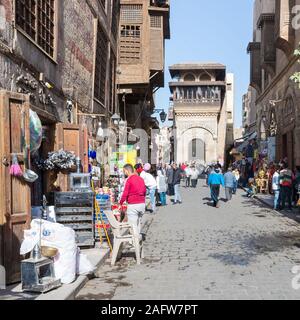 Cairo, Egypt- December 14 2019: Moez Street with local visitors and Sabil-Kuttab of Katkhuda historic building at the far end, Gamalia district, Old Cairo Stock Photo