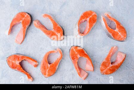 raw trout steak pattern on a blue background top view Stock Photo