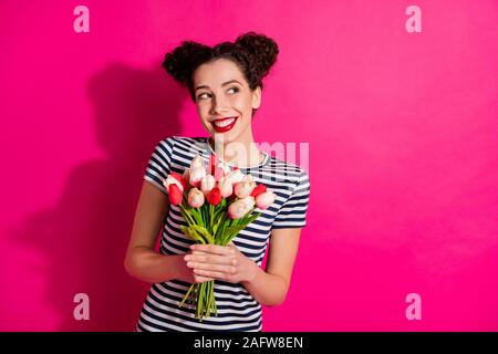 Portrait of curious sweet girl hold bunch of tulips received from secret admirer think feel curious who can it be wear style outfit isolated over pink Stock Photo