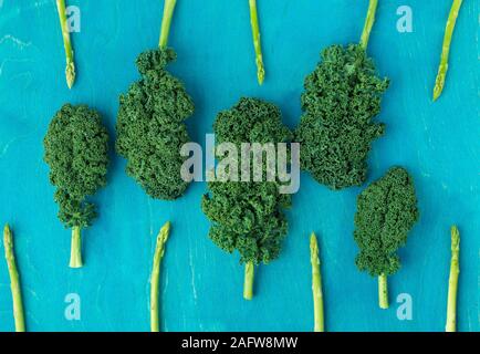 Creative layout made of kale, asparagus. Flat lay. Healthy food concept. Stock Photo
