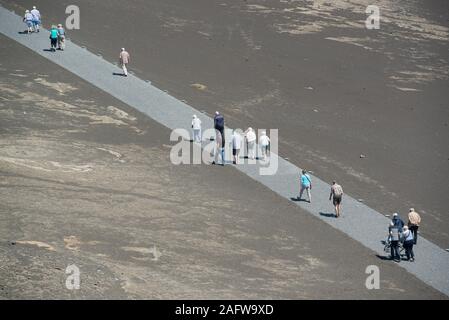 Tourists walking along volcano path, Faial Island, Azores, Portugal Stock Photo