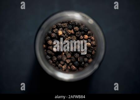 View from above black peppercorns in spice jar Stock Photo