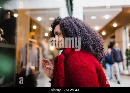 Young woman window shopping in mall Stock Photo