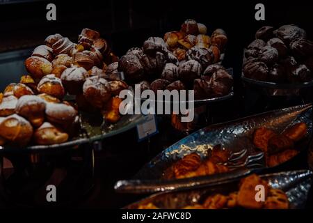 many rolls of different breads in the bakery restaurant Stock Photo