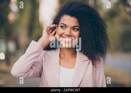 Photo of amazing pretty dark skin lady flirty fixing hair see handsome guy spending weekend time walking green park outside gold autumn weather season Stock Photo