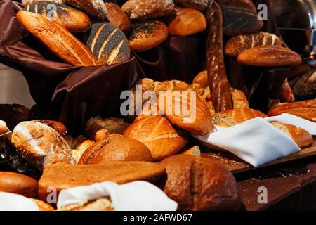 many rolls of different breads in the bakery restaurant Stock Photo