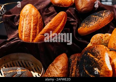 many rolls of different breads in the bakery restaurant Stock Photo