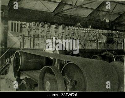 . Electrical world. tchboard, Fig. 8, which is in the old portion of the plant,is mounted on an iron framework, which reaches the entire widthof the building, and the floor of the switchboard gallery is on alevel with the turbine room. Three sets of stairs lead to the switch-? board gallery. The gallery floor is of maple. The posts on the plat-form are of oxidized copper, and the railing is of two-inch polishedbrass. The switchboard panels, twenty-one in number, are of marble.The board is 49 ft. 8 in. long with panels 90 in. high. Beginning at the right, Fig. 8, are two direct-current, ten cir Stock Photo