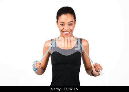 Happy Afro Girl Holding Jump Rope Smiling, Studio Shot Stock Photo