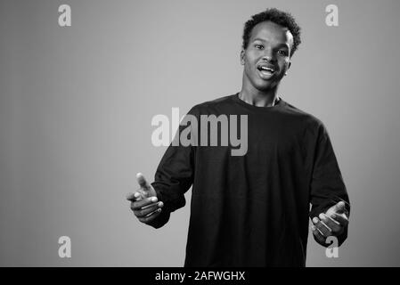 Portrait of young African man against gray background Stock Photo