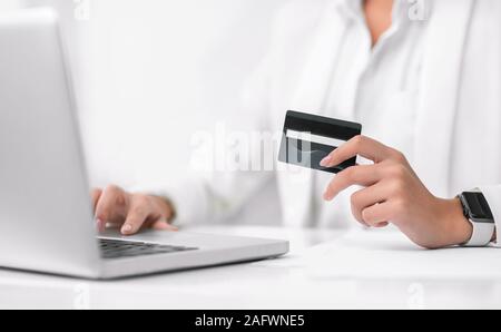 Closeup of girl making purchases using laptop computer Stock Photo