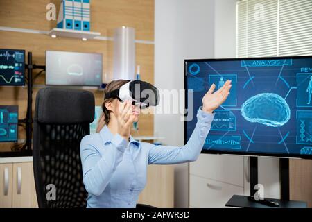 Clinical neurology worker explores virtual reality in the lab. Neuroscience and clinical study Stock Photo