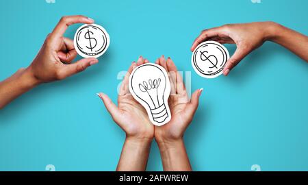 Hands with dollar sign coins and light bulb Stock Photo