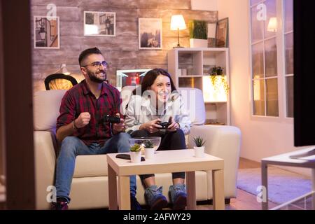 Joyful couple winning video games with joystick on console in studio.  Boyfriend and girlfriend playing online game with controller to win,  feeling happy and relaxed with leisure activity Stock Photo - Alamy