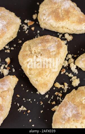 Vertical shot of scones and crumbles on a black surface Stock Photo