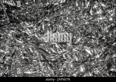 Abstract festive background of a jumble of silver tinsel Stock Photo