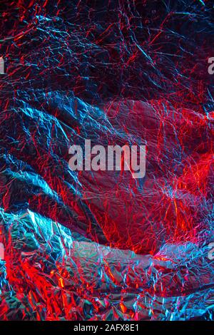 Crumpled red-blue foil paper with textured surface.Texture or background