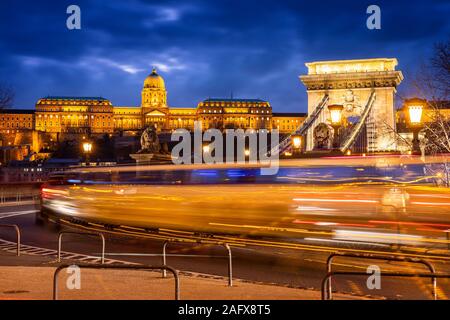 Budapest Chain bridge treffic at night with Buda castle on the hill Stock Photo