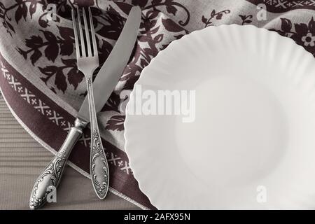 A white empty plate on a linen napkin Stock Photo
