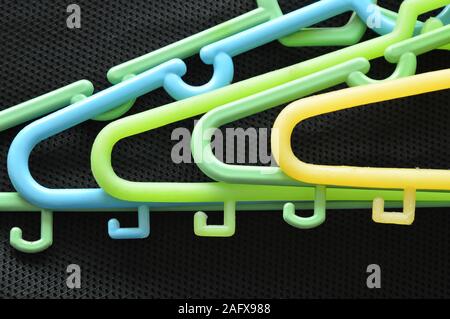 https://l450v.alamy.com/450v/2afx988/colorful-plastic-clothes-hunger-overlay-on-black-fabric-2afx988.jpg