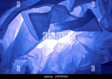 Abstract defocus background backdrop, crumpled paper illuminated by an incandescent lamp. Color of the Year 2020 Classic Blue backdrop background wall Stock Photo