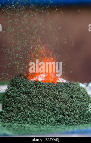 chemical reaction of ammonium dichromate if to set fire to it on the foil Stock Photo