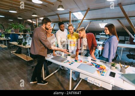 Creative team discussing new product plan, choosing main color Stock Photo