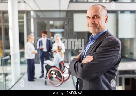 Satisfied manager with arms folded for inclusion in the business team Stock Photo