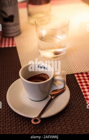 https://l450v.alamy.com/450v/2afxwkj/trieste-italy-september-2019-lavazza-espresso-cup-with-spoon-and-cookie-on-a-table-on-a-warm-summer-day-in-an-italian-street-high-angle-shot-2afxwkj.jpg