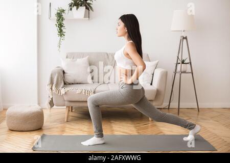 Girl doing aerobics warming up for flexibility, leg stretching Stock Photo