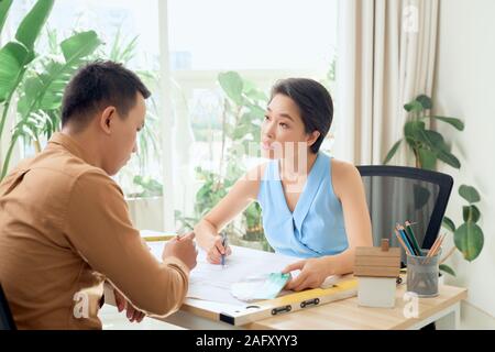 Confident team of engineers working together in a architect studio Stock Photo