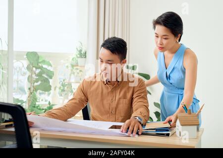Cheerful two architects are discussing new project Stock Photo