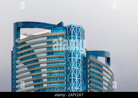 Monaco 7 DEC 2019 Modern skyscraper architecture with blue glass windows in front of the cloudy sky background Stock Photo