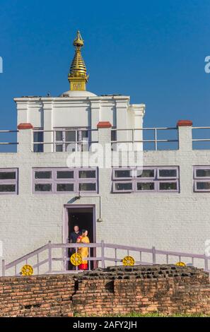 People exiting the Mayadevi temple in Lumbini, Nepal Stock Photo