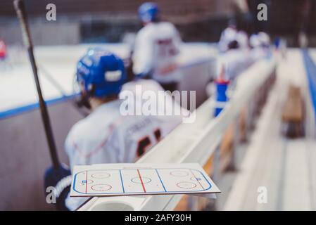 hockey players sit on the bench in the stadium Stock Photo